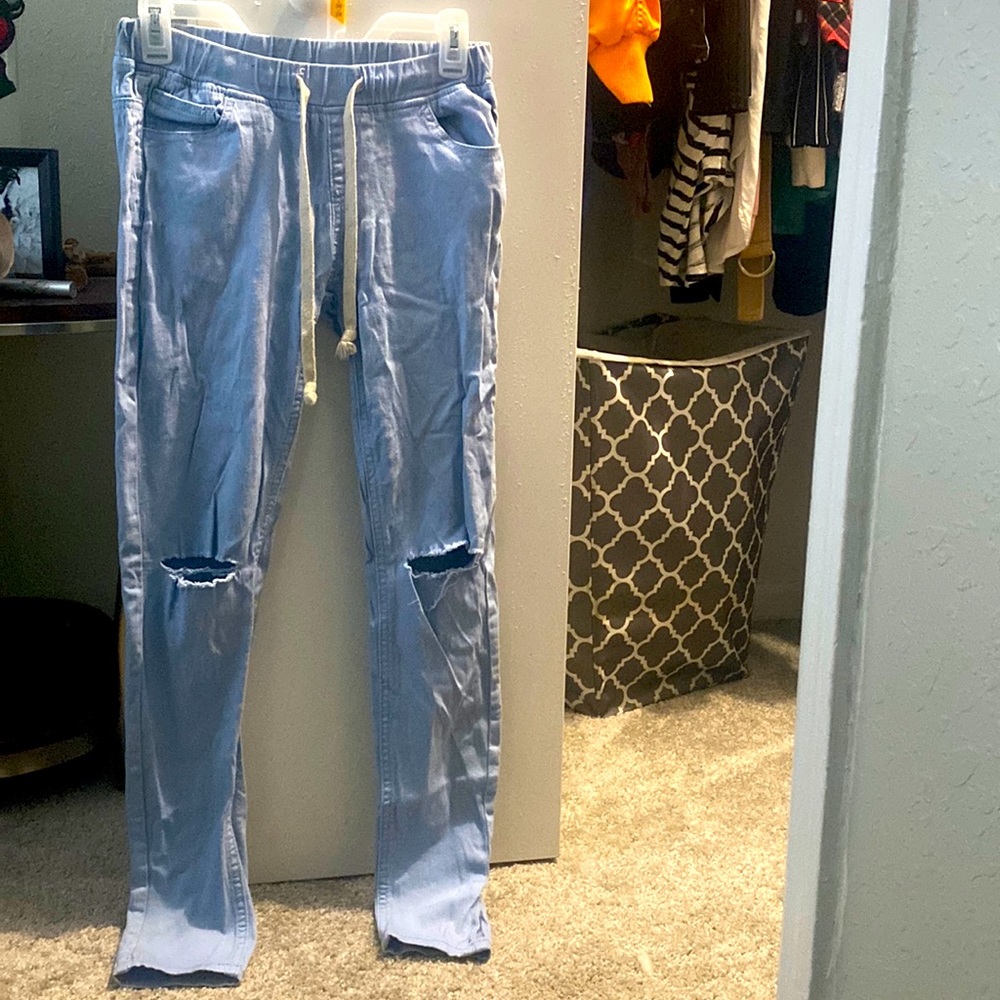 Selling ripped light jeans from American Bazi designed in USA